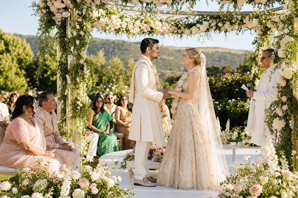 Outdoor wedding ceremony surrounded by flowers