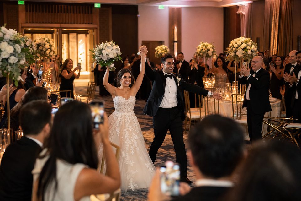 Wedding guests celebrating and capturing photos together