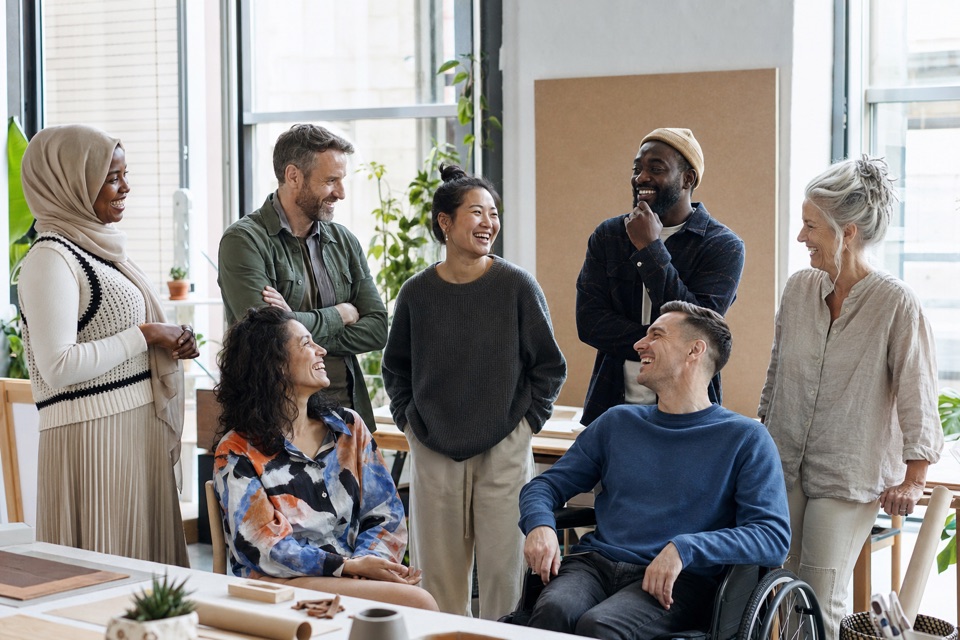A diverse team posing together at a community event